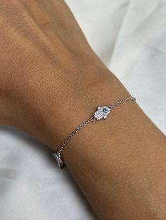 Enhance your style and ward off negative energies with our stunning Hamsa bracelet featuring the evil eye. Crafted with a delicate chain, this bracelet showcases a beautifully detailed Hamsa hand charm adorned with shimmering gemstones or crystals. The Hamsa hand, a powerful symbol of protection and good luck, adds a touch of mystique to your ensemble. Embrace positive vibes and elevate your look with this elegant accessory. -- Material: Solid Sterling Silver, 14k Gold Plated -- Stones: Round sa Evil Eye Bracelet Silver, Symbol Of Protection, The Evil Eye, Hamsa Bracelet, Round Sapphire, Wedding Jewelry Bracelets, Delicate Chain, Evil Eye Bracelet, Hamsa Hand