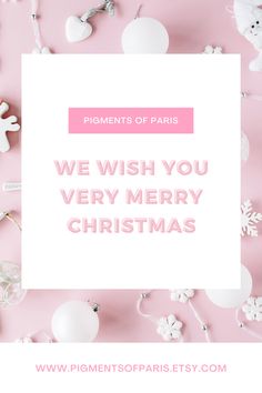 the words we wish you very merry christmas on pink paper surrounded by ornaments and decorations