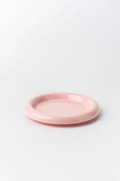 a pink plate sitting on top of a white table