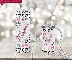 two personalized flasks with hearts and the word mom printed on them are sitting next to each other