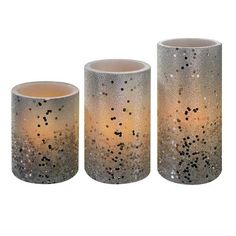 three vases with glitter on them sitting next to each other in front of a white background