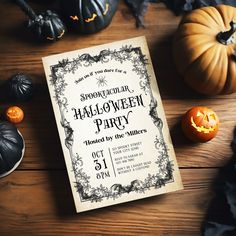 a halloween party with pumpkins and other decorations on a wooden table next to an old book