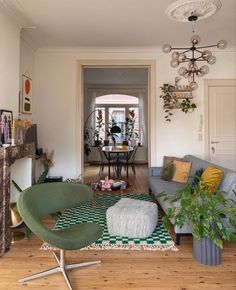 a living room filled with furniture and a fire place next to a dining room table