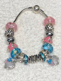 Pandora like charm bracelet MOM or March Birthday, Aquamarine colors. Iridescent pink and blue, cheerful. European fit style. gift for her, includes two dangle hearts with opal like colors and blue and pink butterflies, very sweet Silver plated bracelet.  Barrel snap closure is stamped pandora, faux. Beads are metal alloy, pave rhinestone beads -silver and resin. Very glittery and pretty. lightweight and comfortable. Czech clay rhinestone  and iridescent beads that are very sought after. Romanti European Charm Bracelet, Pandora Charms Pink, Pandora Bracelet Charms Ideas, Pandora Bracelet Designs, Pandora Pink, Blue Charm, March Birthday, Aquamarine Colour, Silver Plated Bracelet