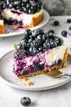 a slice of blueberry cheesecake on a plate with a fork