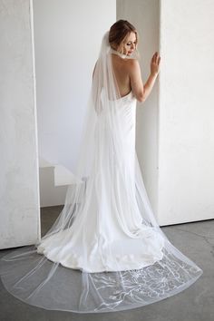 a woman in a white wedding dress and veil