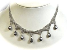 "Shimmering Silver Plated Bead Chain is accented by 7.5mm by 9.5mm teardrop grey Black Pearls that hang so delicate and create movement from each point.  The necklace can be adjusted from 15\" to 18.25\" Long. Necklace has a 3.25\" extender. The chain that holds these beautify black grey pearls are a teardrop shape. REF: \"Midnight\" Necklace" Elegant Beaded Drop Necklace, Silver Drop Necklace With Pearl Chain, Elegant Beaded Teardrop Drop Necklace, Elegant Gray Jewelry With Beaded Chain, Elegant Teardrop Dangling Beads Necklaces, Elegant Teardrop Necklaces With Dangling Beads, Elegant Teardrop Dangling Beads Necklace, Elegant Teardrop Necklace With Dangling Beads, Silver Teardrop Necklace With Beaded Chain