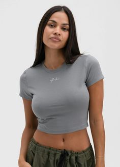 Short Sleeve Baby Tee
Cropped Fit at Waist
Crew Neckline
Custom Front Graphic
55% Cotton 37% Modal 8% Spandex Gray Fitted Cotton Top, Fitted Gray Cotton Tops, Fitted Gray Cotton Crop Top, Trendy Cropped Tops With Medium Support, Fitted Cropped Basic Tops, Spring Gray Athleisure Tops, Gray Stretch Cropped Top, Gray Fitted Crop Top, Fitted Gray Crop Top