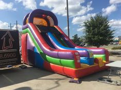 an inflatable slide is being loaded onto the back of a truck