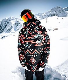 a man standing on top of a snow covered slope wearing skis and goggles