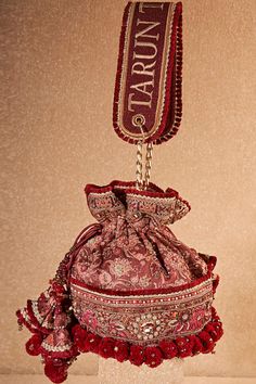 Buy Maroon Glass Beads Floral Thread And Sequin Embroidered Potli Bag by Tarun Tahiliani Online at Aza Fashions. Luxury Embroidered Festive Bag, Red Festive Bags For Reception, Festive Red Bags For Reception, Luxury Embroidered Potli Bag In Pouch Shape, Luxury Embroidered Potli Pouch Bag, Luxury Embroidered Pouch Potli Bag, Luxury Embroidered Potli Bag For Festive Occasions, Bohemian Potli Bag For Receptions And Festivals, Wedding Bags With Multicolor Resham Embroidery