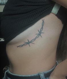 barbed wire tattoo around the side of the breast Spine Tattoos Barbed Wire, Longhorn Barbed Wire Tattoo, Barbed Wire Rib Tattoo, Tattoo Ideas Female Behind Elbow, Barb Wire Tramp Stamp, Barbed Wire Hip Tattoo, Western Lower Back Tattoo, Western Barbed Wire Tattoo, Fine Line Barbed Wire Tattoo