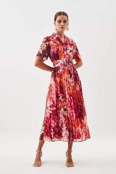 Bursting With Joyful Colour, This Floral Midi Dress Boasts A Concise Cut That Balances A Button-Up Bodice With A Cascading Pleated Skirt. Complete With A Silhouette-Defining Belted Waist, Pair This Vibrant Piece With A Tonal Tulle Headpiece And Matching Stilettos For Summer Weddings.Spread Collarbutton-Up Bodicebelted Waistpleated Skirtmidi Length Summer A-line Midi Dress With Accordion Pleats, Formal Floral Print Shirt Dress For Summer, Floral Print Short Sleeve Midi Dress For Formal Occasions, Pleated Midi Dress For Garden Party, Spring A-line Midi Dress With Pleated Skirt, Spring Fitted Belted Dress With Pleated Waist, Fitted Pleated Belted Summer Dress, Fitted Pleated Belted Dress For Summer, Formal Short Sleeve Floral Print Midi Dress