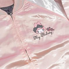 This super cute jacket is inspired by the iconic “sukajan” or the Japanese baseball varsity jacket that’s known for its large back design! Wear this shiny pink and white bomber jacket to keep you warm when it’s rainy! It has long sleeves, a small My Melody embroidery at the front, and a bigger version at the back! Made from 100% satin-like polyester Comes with a zipper closure and side pockets Width: 58 cm Length: 67 cm Sleeve length: 85 cm Trendy Long Sleeve Varsity Jacket With Zipper Closure, Trendy Pink Varsity Jacket For Streetwear, Kawaii Outerwear For Fall Streetwear, Kawaii Fall Streetwear Outerwear, Kawaii Style Outerwear For Fall Streetwear, Pink Long Sleeve Varsity Jacket For Streetwear, Pink Harajuku Outerwear For Fall, Pink Hooded Varsity Jacket For Streetwear, Spring Trendy Hooded Varsity Jacket