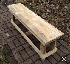 a wooden bench sitting on top of a brick walkway