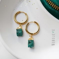 💚 Get your green on with these Malachite Hoop Earrings! Made with raw crystal jewelry, these Boho Crystal Earrings are the perfect accessory for any nature lover. With a stunning green hue. The huggie hoop design makes them easy to wear and versatile, perfect for both formal and casual occasions 💚 ⭒ Material: Stainless Steel  ⭒ Finish: Silver * Gold * Rose Gold ⭒ Hoop Size:  thickness: 2.5mm / internal diameter: 10mm or 14mm ⭒ Gemstone size & plating: approx 8-10 mm / brass electroplated ⭒ Eac Small Hoop Green Earrings For May Birthstone, Green Gemstone Hoop Earrings As Gift, Green Gemstone Dangle Hoop Earrings, Green Gemstone Hoop Earrings For Gift, Green Huggie Earrings With Matching Set, Small Green Pierced Hoop Earrings, Green Dangle Hoop Earrings As Gift, Green Dangle Hoop Earrings, Green Gemstone Hoop Earrings