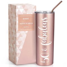 a pink and gold tumbler next to a cardboard box with a straw in it