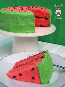 a slice of watermelon cake on a white plate with a green frosting