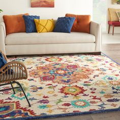 a living room with a couch, chair and rug