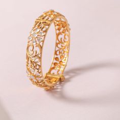 Description Modern | Elegant | Chic Inspired by the most popular baroque patterns, this collection is crafted in 3d carvings of flora and fauna. The combination of Moissanites and unique gold plating enhances its sparkle. The pieces are lightweight and perfect for both traditional and contemporary styles. This splendid and ultra-charming silver bangle cuff is handcrafted with floral motifs set in Moissanites and golden baroque floral patterns which, in turn, is the central focus of this elegant Delicate Gold Jewelry For Festive Occasions, Exquisite Bracelets With Intricate Design, Luxury Gold Jewelry For Festive Season, Elegant Jeweled Yellow Gold Bracelet, Festive Luxury Gold Jewelry, Elegant Gold Jeweled Bangle, Elegant 22k Gold Bracelet For Wedding, Elegant Jeweled Gold Bangle, Exquisite Gold Bracelets With Single Cut Diamonds