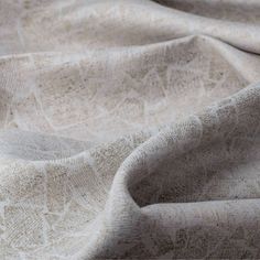 a close up view of the fabric on a bed sheet that has been made to look like an intricate pattern