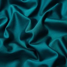 a close up view of a teal green fabric