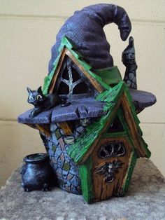 a small house with a witches hat on top