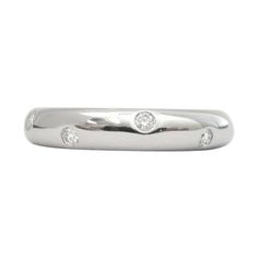 a white gold wedding band with three diamonds