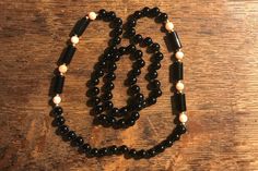 "This is a beautiful necklace!  It is approximately 8mm coral and black onyx round beads with 14k accent beads.  It is long and measures approximately 32\".  All beads are hand knotted on a black cord.  Excellent condition! A wonderful addition to any wardrobe.  Thank you for visiting Vintage Great Gets 💕" Vintage Black Beaded Necklace With Gemstone Beads, Vintage Black Gemstone Beads Necklace, Elegant Hand-strung Onyx Necklaces, Elegant Onyx Hand-strung Necklaces, Elegant Hand-strung Onyx Necklace, Elegant Hand-strung Black Beaded Necklace, Elegant Onyx Hand-strung Necklace, Elegant Hand-strung Black Necklace, Elegant Black Hand-strung Necklace