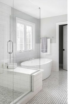 a bathroom with a tub, sink and shower stall in the middle of the room