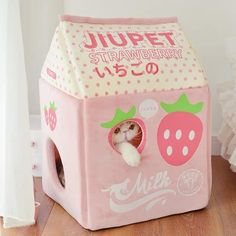 a pink toy house with a white cat in it's mouth and the words jupeet strawberry on top