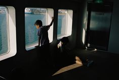 two people looking out the windows of a boat