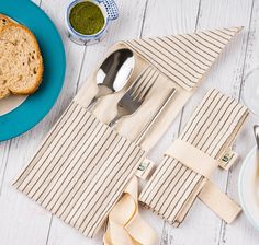 a table set for two with silverware and napkins