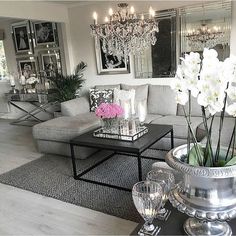 a living room filled with furniture and a chandelier