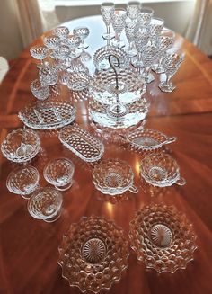 an assortment of glass dishes on a wooden table