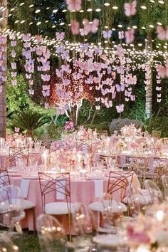 the tables are set with pink linens and flowers