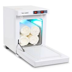 a white machine with towels in it on a white surface and light coming from the door