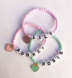 Girls Name Bracelets - Candy Colored The sweetest name bracelet for your little girl. And makes a great gift or baby shower gift ✨ Candy colored 3mm seed beads with personalized name and heart charm Color options available* CARING TIPS FOR YOUR JEWELRY ⭐️Treat and store with care. ⭐️ For longevity, avoid exposing your jewelry to water. ⭐️ Avoid having direct contact with lotions, perfumes, sanitizers as these chemicals may cause discoloration of your jewelry. Cute Personalized Jewelry For Party Favors, Cute Name Bracelet With Round Beads For Birthday, Cute Heart Bracelet With Round Beads For Valentine's Day, Cute Custom Name Beaded Bracelets For Birthday, Cute Letter Beads Stretch Bracelet For Valentine's Day, Cute Stretch Bracelet With Letter Beads For Valentine's Day, Cute Heart Beads Charm Bracelet For Valentine's Day, Cute Heart Beads Beaded Bracelets For Valentine's Day, Trendy Name Bracelet With Heart Beads For Gift