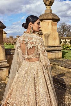 This lehenga set features all-over rose gold metallic work with crystal, pearl, and sequin. The ensemble is paired with a full-sleeved blouse and shows tassels at the wrist and blouse waist and a matching net dupatta.From Seema Gujral's A Royal Affair collection. DELIVERY TIMEPlease allow 8-12 weeks for your outfit to arrive. FABRIC DETAILSNet Professional cleaning only. Glamorous Designer Lehenga For Eid, Glamorous Embellished Choli For Eid, Glamorous Embellished Lehenga For Eid, Glamorous Semi-stitched Lehenga For Eid, Glamorous Sets With Intricate Embroidery For Eid, Glamorous Festive Lehenga For Eid, Glamorous Designer Choli For Eid, Glamorous Hand Embellished Sets For Eid, Glamorous Long Sleeve Sets With Intricate Embroidery