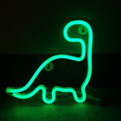 a neon green dinosaur light up in the dark