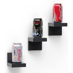 three black shelves holding two cans of coca - cola and a can of diet coke