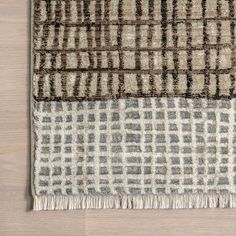 a rug with two different colored squares on top of it, one is brown and the other is beige