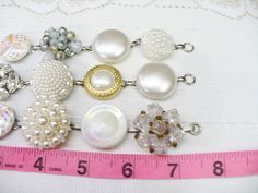 These gorgeous bracelets are fashioned from 'repurposed' vintage earrings. The earrings range from crystal clear rhinestones, faux pearls, ivory, crystals, Aurora Borealis - gold accents, silver accents -- all on silver tone and gold tone . Great bracelet for that special occasion, bride or bridesmaid. Wedding APPEAL! AMAZING sparkle for the BRIDE or bridesmaid! They sit on a bracelet that is aprox. 7.25 inches long and is matte silver tone - nickel free and oxidized. I use only top quality adhe Vintage Pearl Embellished Jewelry Gift, Adjustable Vintage Pearl White Jewelry, Vintage Adjustable Pearl White Jewelry, Nickel Free Round Beads Bracelet For Wedding, White Jewelry With Pearl Buttons For Parties, Silver Jewelry With Pearl Buttons As Gift, Nickel Free Wedding Bracelet With Round Beads, White Pearl Button Jewelry For Party, Pearl Jewelry With Extender For Wedding