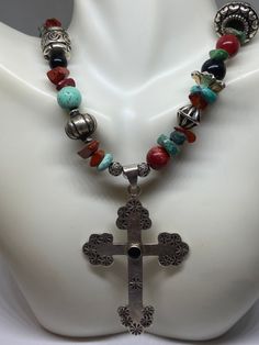 "This piece is so beautiful. It is a genuine, vintage, Taxco multi stone and sterling silver cross necklace. The necklace is 22 inches. The necklace features gorgeous, natural blue turquoise, red coral, carnelian, black onyx and sterling silver beads with a huge stamped sterling silver and black onyx cross. The stones are nuggets, round beads, rondelle beads. The sterling silver beads are stunning with etchings, including flowers, scrollwork, ribbed and other designs; some beads are shaped like Bohemian Crucifix Necklace As Gift, Bohemian Crucifix Necklace As A Gift, Silver Bohemian Cross Necklace, Spiritual Cross Turquoise Necklace For Gift, Spiritual Turquoise Cross Necklace As Gift, Southwestern Style Silver Cross Necklace, Handmade Southwestern Style Cross Pendant Jewelry, Southwestern Style Silver Cross Necklaces, Southwestern Style Silver Cross Pendant Necklace