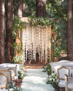 an outdoor ceremony with white flowers and greenery