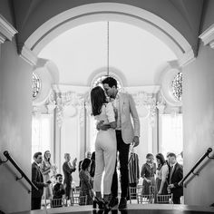 a man and woman are kissing in front of an audience