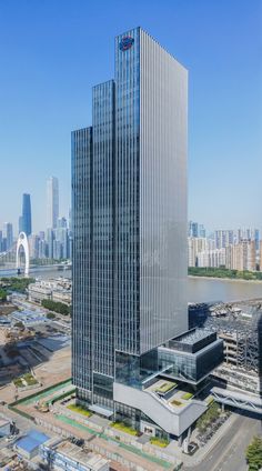 an aerial view of a very tall building in the middle of a city with skyscrapers