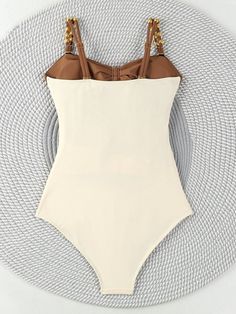 Turn heads at the beach with our Colorblock Cut-Out One-Piece Swimsuit. This sexy, plain-patterned swimsuit features eye-catching cut-out details and a flattering bikini bottom type. Designed with a wireless bra for comfort, it has spaghetti straps and a sleeveless cut for a sleek, modern look. Made from high-stretch knitted fabric, this short-length swimsuit ensures a perfect fit and ease of movement. Perfect for making a bold statement by the pool or on the sand. Composition: 80% Polyamide, 20 Solid Color Beachwear Bodysuit For Beach Season, Solid Color Bodysuit For Sunbathing In Beach Season, Beachwear Bodysuit For Sunbathing With Lined Body, Solid Color Beachwear Bodysuit For Sunbathing, Solid Color Bodysuit For Sunbathing During Beach Season, Chic Nylon Swimwear For Vacation, Solid Color One-piece Beachwear For Vacation, Solid One-piece Swimsuit For Beach Season, Solid Color One Piece For Beach Season