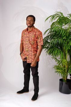 This soft and lightweight African print (Ankara)  men's shirt is perfect for summer. It is made of cotton and has a classic button down collar. The bright color will match with any outfit which makes it perfect for a night out on the town, a special occasion, casual wear or work.  The Shirt is named after the street style dance from Nigeria; Shoki Short sleeves  100% Ankara wax cotton (exclusive of ornamentation) One breast pocket  Patrick is 5'9" and wearing size XL Handmade in Nigeria Fitted Button-up Hawaiian Shirt For Summer, Fitted Summer Hawaiian Button-up Shirt, Orange Cotton Summer Shirt, Summer Orange Cotton Shirt, Summer Patterned Button-up Shirt, Cotton Hawaiian Shirt With Relaxed Fit, Patterned Cotton Hawaiian Shirt, Relaxed Fit, Patterned Cotton Hawaiian Shirt With Relaxed Fit, Fitted Collared Hawaiian Shirt For Summer