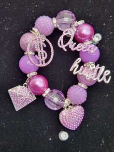 -Purple Bling Stretch Charm Bracelet -Bracelet has five silver and purple bling charms -Beads are 20mm -Place bracelet on carefully by gently rolling it onto the wrist Personalized Purple Beaded Bracelet, Personalized Purple Round Beads Stretch Bracelet, Personalized Purple Stretch Bracelet With Round Beads, Adjustable Purple Bracelets With Charms, Purple Charm Bracelet Jewelry, Elegant Purple Charm Bracelet With Round Beads, Purple Charm Bracelet Gift, Personalized Purple Bracelet Jewelry, Adjustable Purple Bangle Charm Bracelet